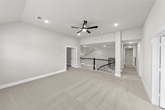 carpeted spare room with ceiling fan and lofted ceiling