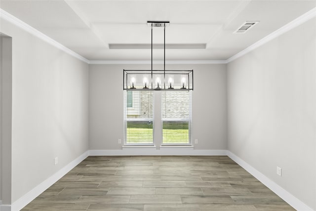 unfurnished dining area featuring light hardwood / wood-style floors, crown molding, and a notable chandelier