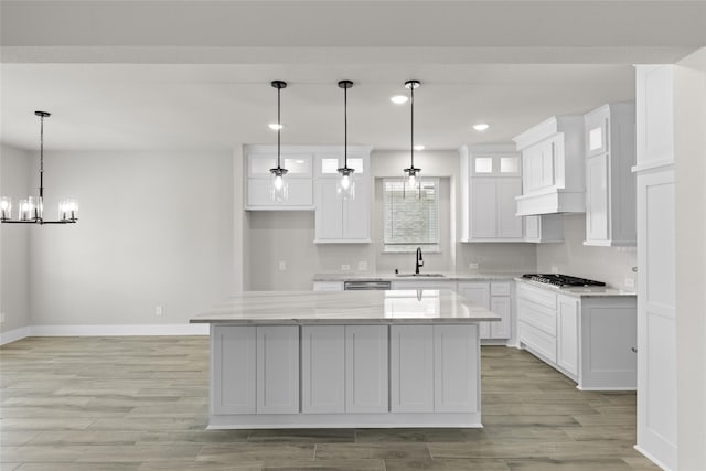 kitchen featuring pendant lighting, white cabinetry, and a center island