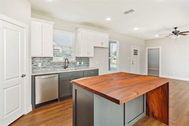 kitchen with dishwasher, a wealth of natural light, gray cabinetry, and white cabinetry