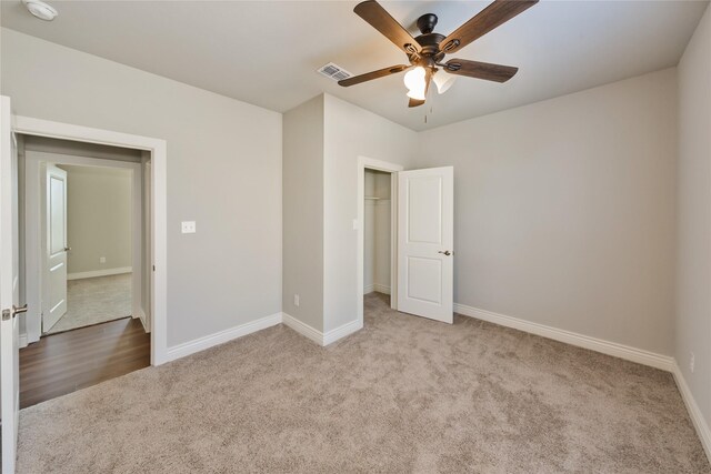 bathroom featuring hardwood / wood-style floors, a shower with shower door, vanity, and toilet