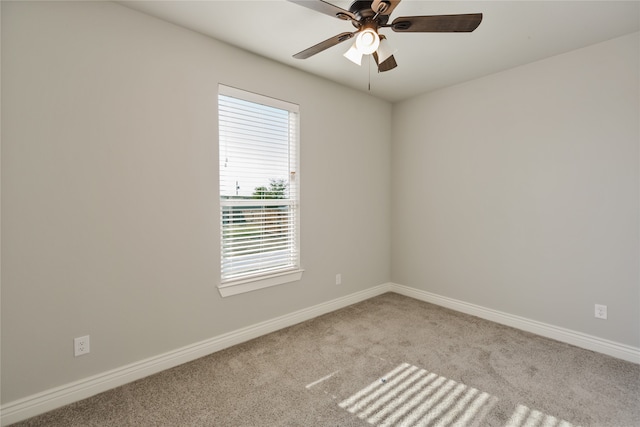 carpeted spare room featuring ceiling fan