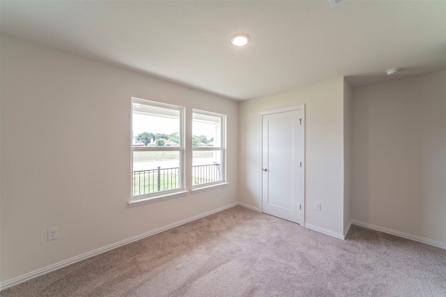 unfurnished bedroom featuring light colored carpet