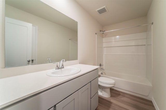 full bathroom featuring vanity, bathtub / shower combination, toilet, and hardwood / wood-style floors