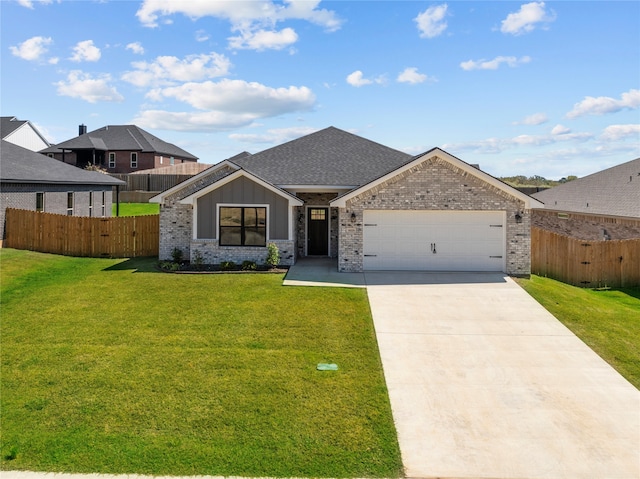 view of front of property featuring a garage and a front lawn