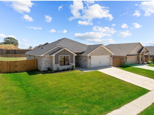 ranch-style home featuring a front yard and a garage