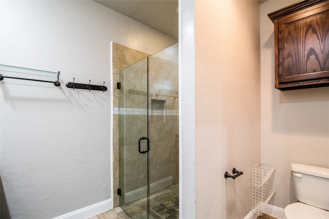 bathroom featuring toilet and walk in shower