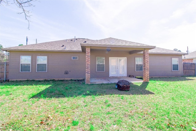 rear view of house with an outdoor fire pit, a patio area, and a yard