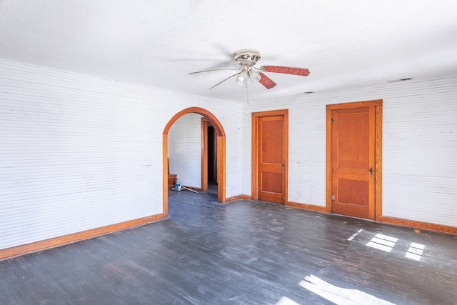 spare room featuring ceiling fan, a textured ceiling, and dark hardwood / wood-style floors