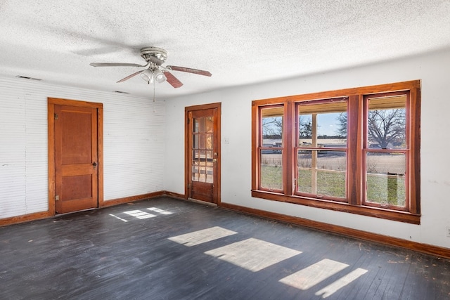 unfurnished room with a textured ceiling, ceiling fan, and dark hardwood / wood-style floors