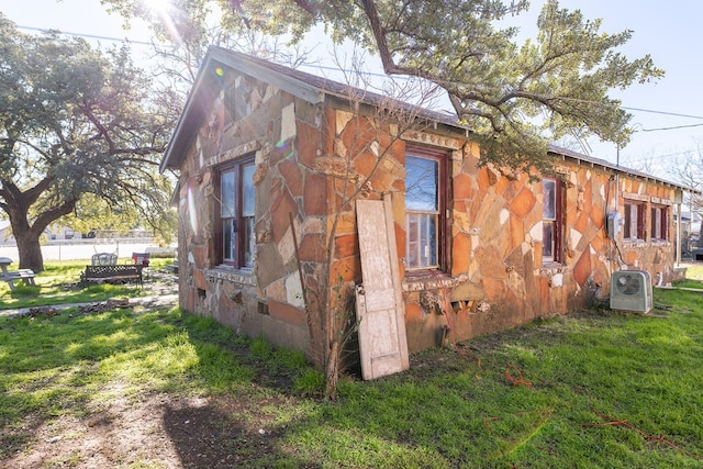 view of side of home featuring a yard