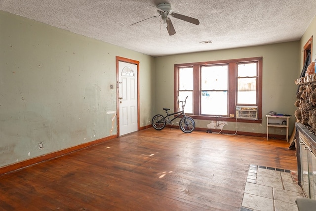 interior space with a textured ceiling, ceiling fan, and wood-type flooring