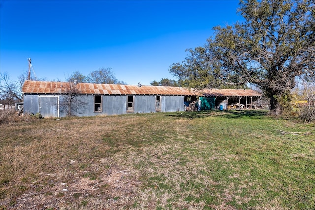 rear view of property featuring a yard