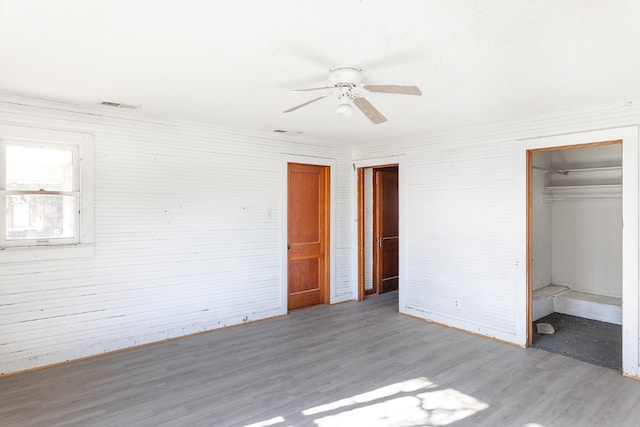 unfurnished bedroom with ceiling fan and light hardwood / wood-style floors