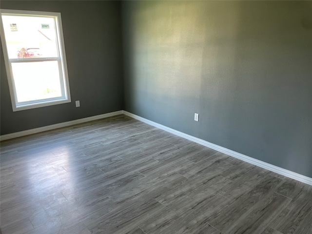 unfurnished room with dark wood-type flooring