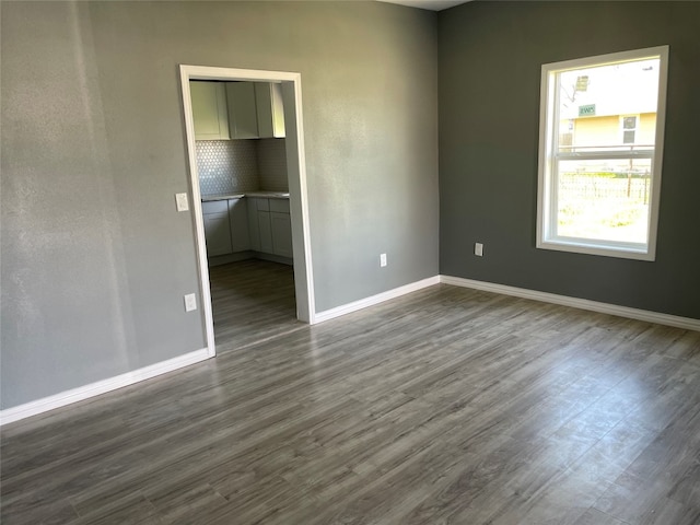 spare room featuring dark wood-type flooring