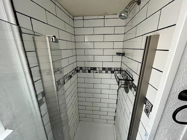 bathroom with tiled shower