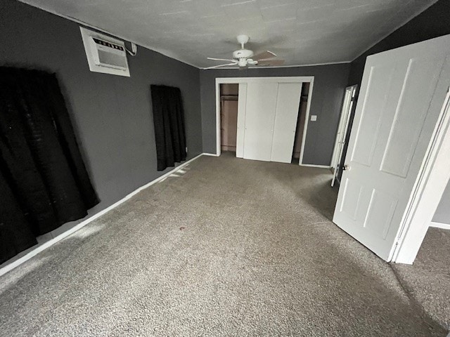 carpeted empty room featuring vaulted ceiling and ceiling fan