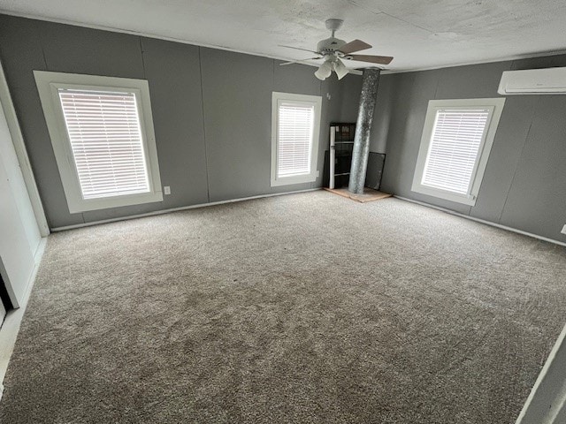 carpeted empty room with ceiling fan and an AC wall unit