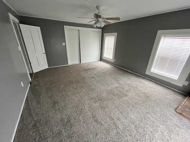 unfurnished bedroom featuring ceiling fan and carpet floors