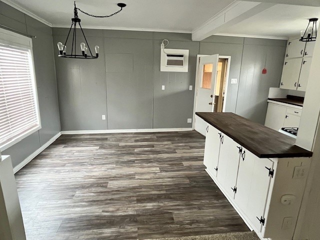 kitchen featuring white cabinets, hanging light fixtures, a chandelier, and dark hardwood / wood-style flooring