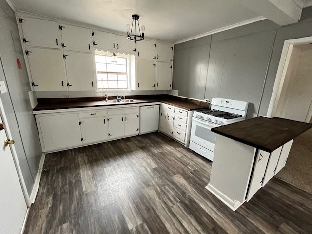 kitchen with dark wood-type flooring, decorative light fixtures, white cabinets, and white range with gas cooktop