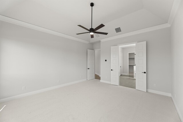 unfurnished bedroom featuring ceiling fan, crown molding, carpet, and lofted ceiling