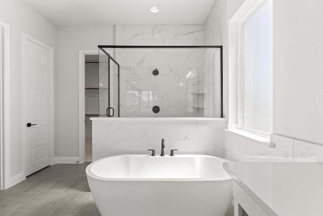 bathroom featuring tile patterned floors and separate shower and tub