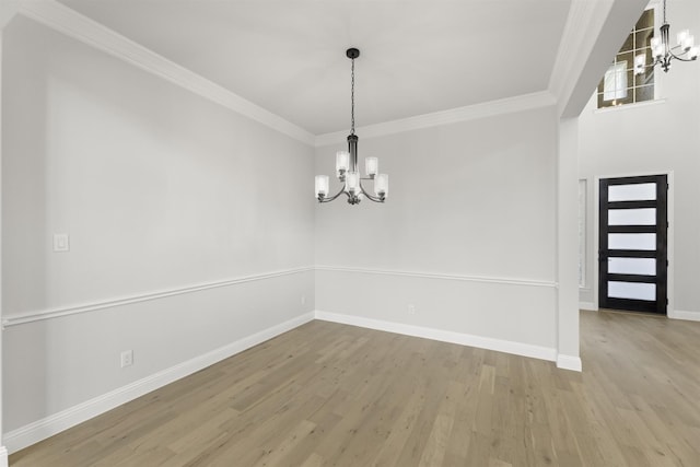 interior space with crown molding, light hardwood / wood-style floors, and a notable chandelier