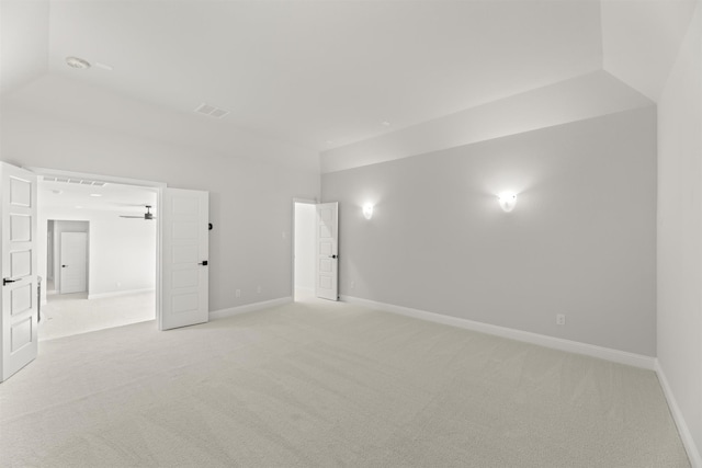 carpeted empty room with ceiling fan and vaulted ceiling