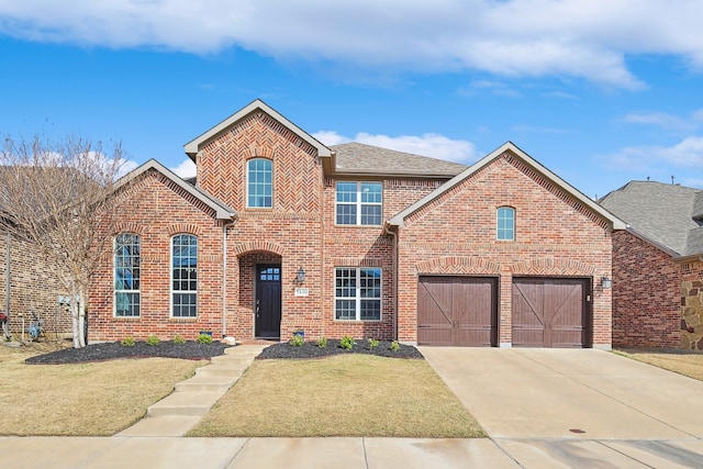 view of front property featuring a garage and a front lawn