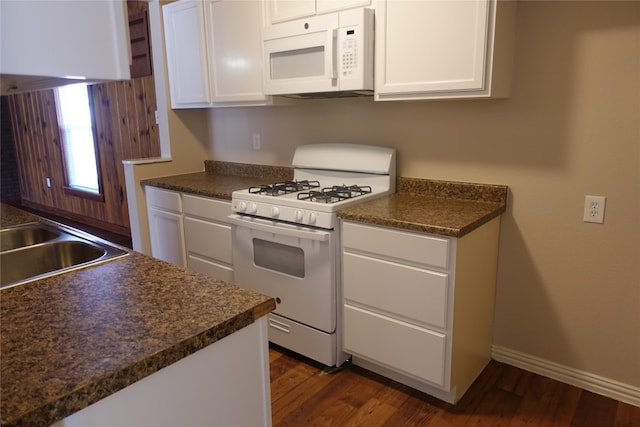 kitchen with white appliances, white cabinetry, and dark wood-type flooring