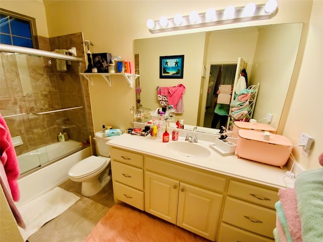 full bathroom featuring vanity, toilet, and bath / shower combo with glass door