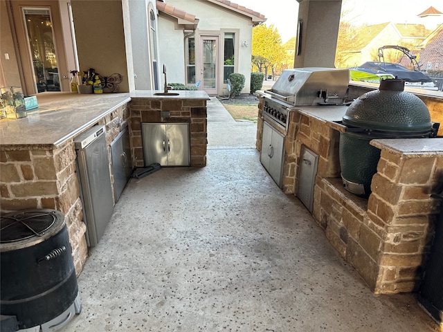 view of patio / terrace with sink, a grill, and an outdoor kitchen