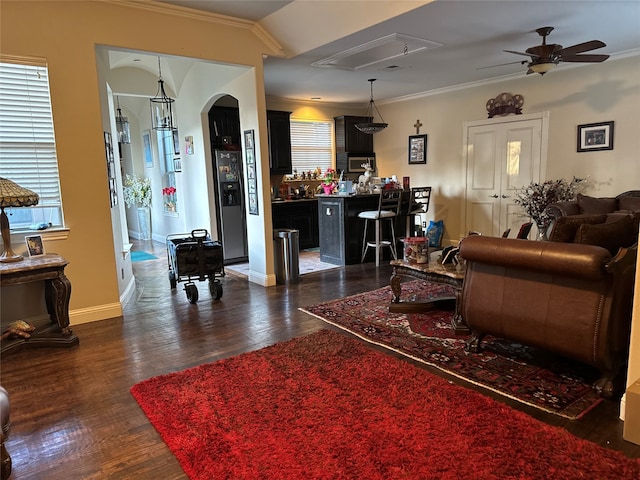 living room featuring ceiling fan, crown molding, and dark hardwood / wood-style floors