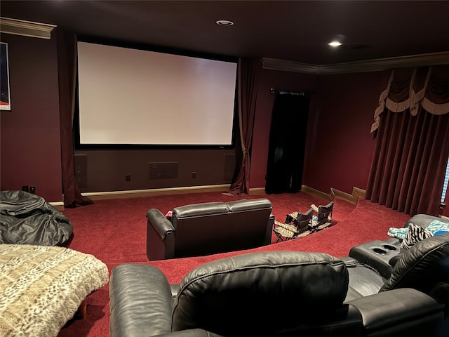 carpeted home theater featuring crown molding