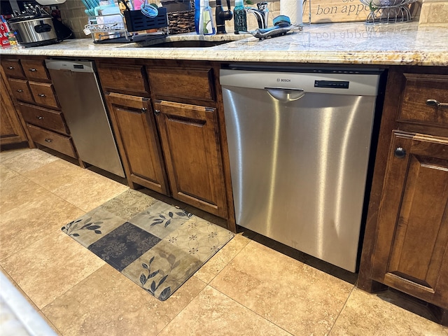 kitchen with light tile floors and stainless steel dishwasher