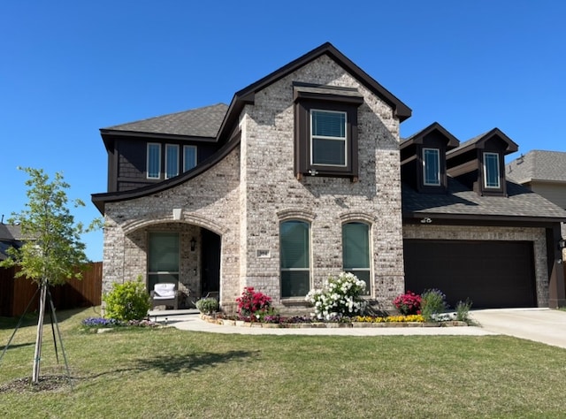 view of front of property with a garage and a front yard