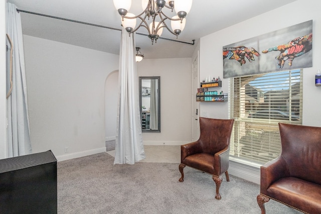 sitting room with a chandelier, plenty of natural light, and light colored carpet