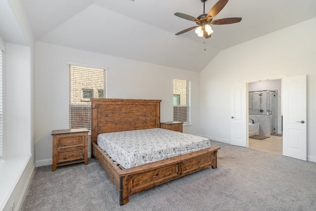 carpeted bedroom with ensuite bath, ceiling fan, and lofted ceiling