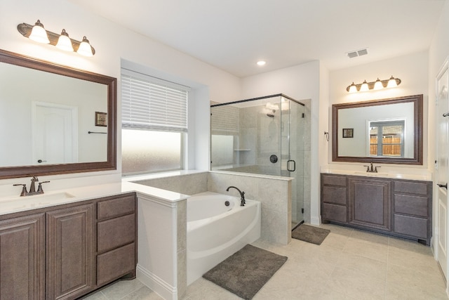 bathroom with independent shower and bath, vanity, and tile floors