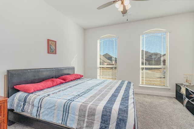 carpeted bedroom with multiple windows and ceiling fan