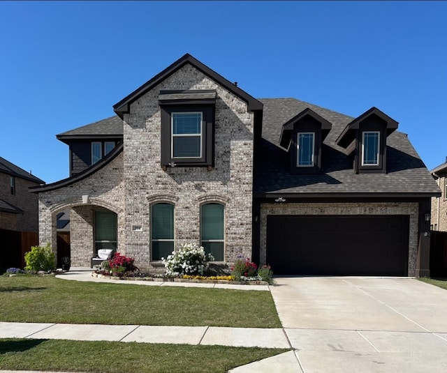 view of front of property with a garage and a front yard