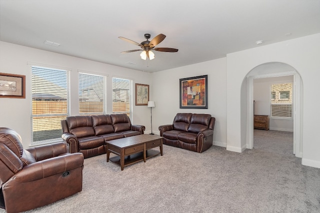 carpeted living room with ceiling fan