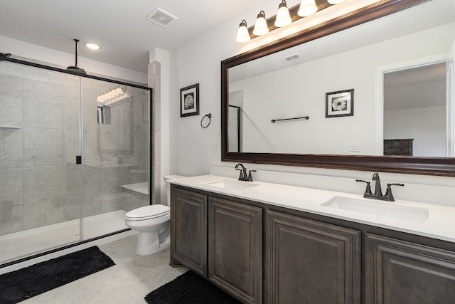 bathroom with dual bowl vanity, toilet, tile flooring, and a shower with door