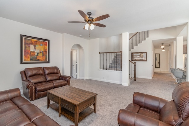 living room with light colored carpet and ceiling fan