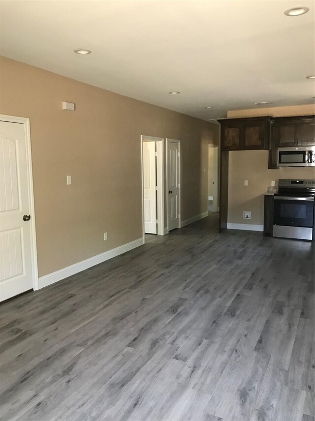 kitchen featuring appliances with stainless steel finishes, hardwood / wood-style flooring, and dark brown cabinets