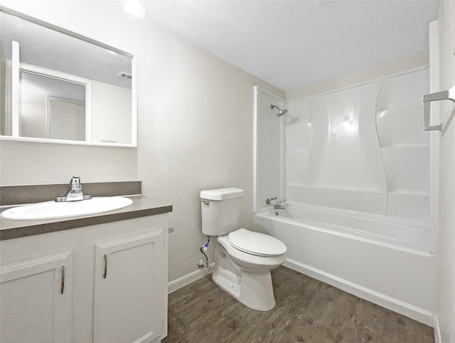 full bathroom with shower / washtub combination, toilet, vanity, and hardwood / wood-style flooring