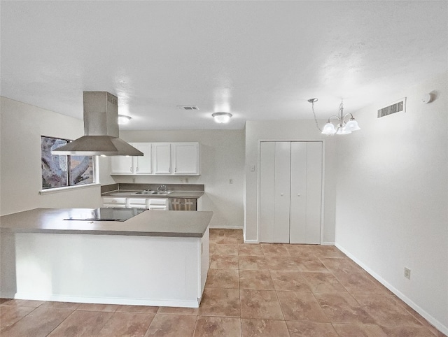 kitchen with white cabinets, stovetop, a notable chandelier, island range hood, and light tile flooring