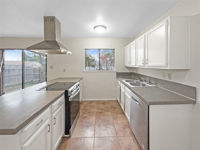 kitchen with appliances with stainless steel finishes, sink, white cabinetry, and wall chimney exhaust hood